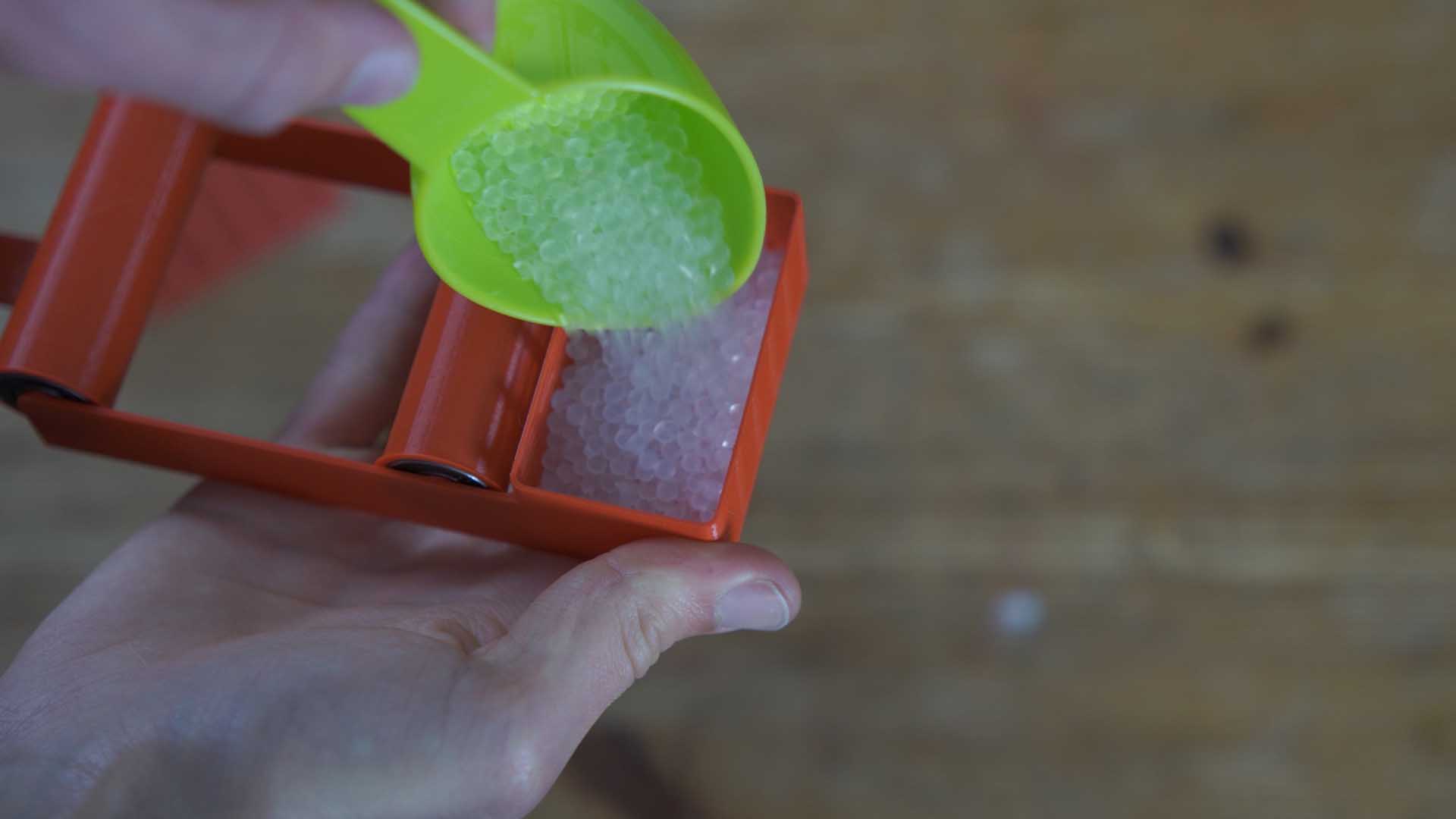 Filling the desiccant tray with silica gel and sealing the assembled dry box